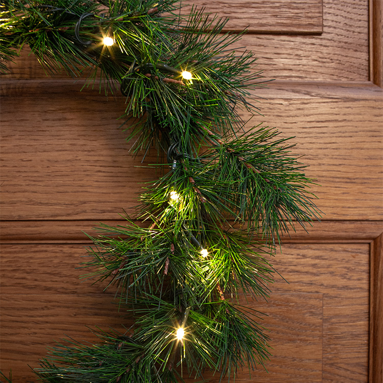 Battery powered door wreath with timer