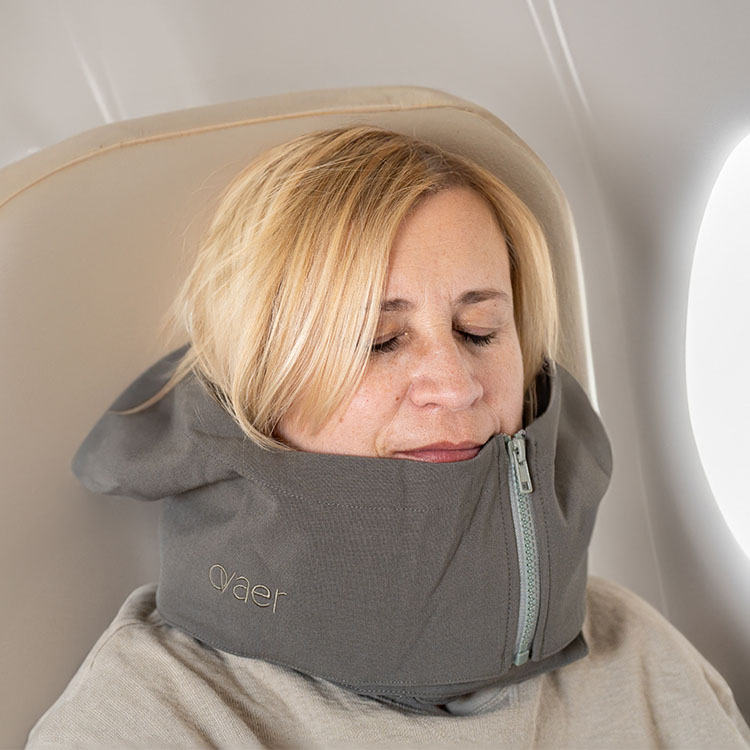 Travel pillow with a hood